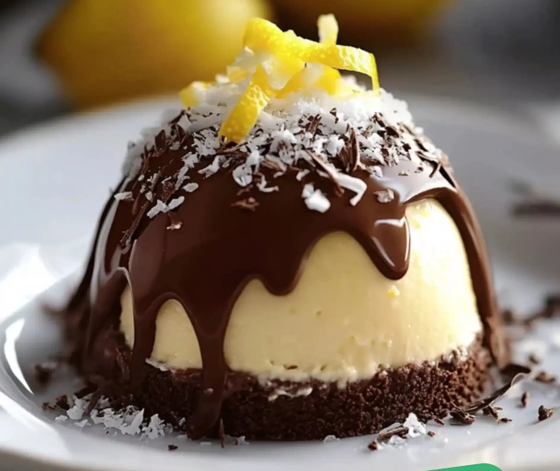Chocolate Lemon Mousse Dome with cookie crunch base topped with lemon zest.