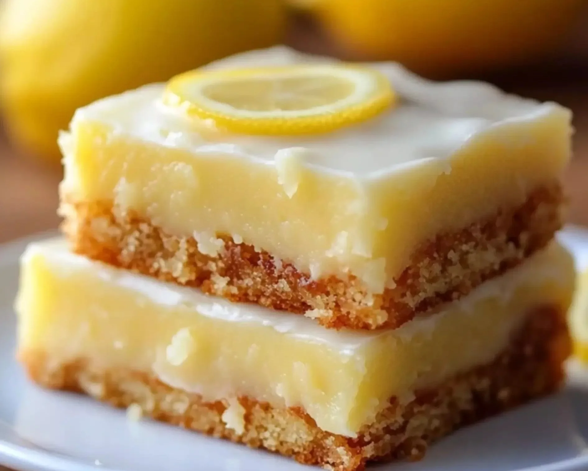 Delicious zesty lemon brownies on a plate, perfect dessert for lemon lovers.