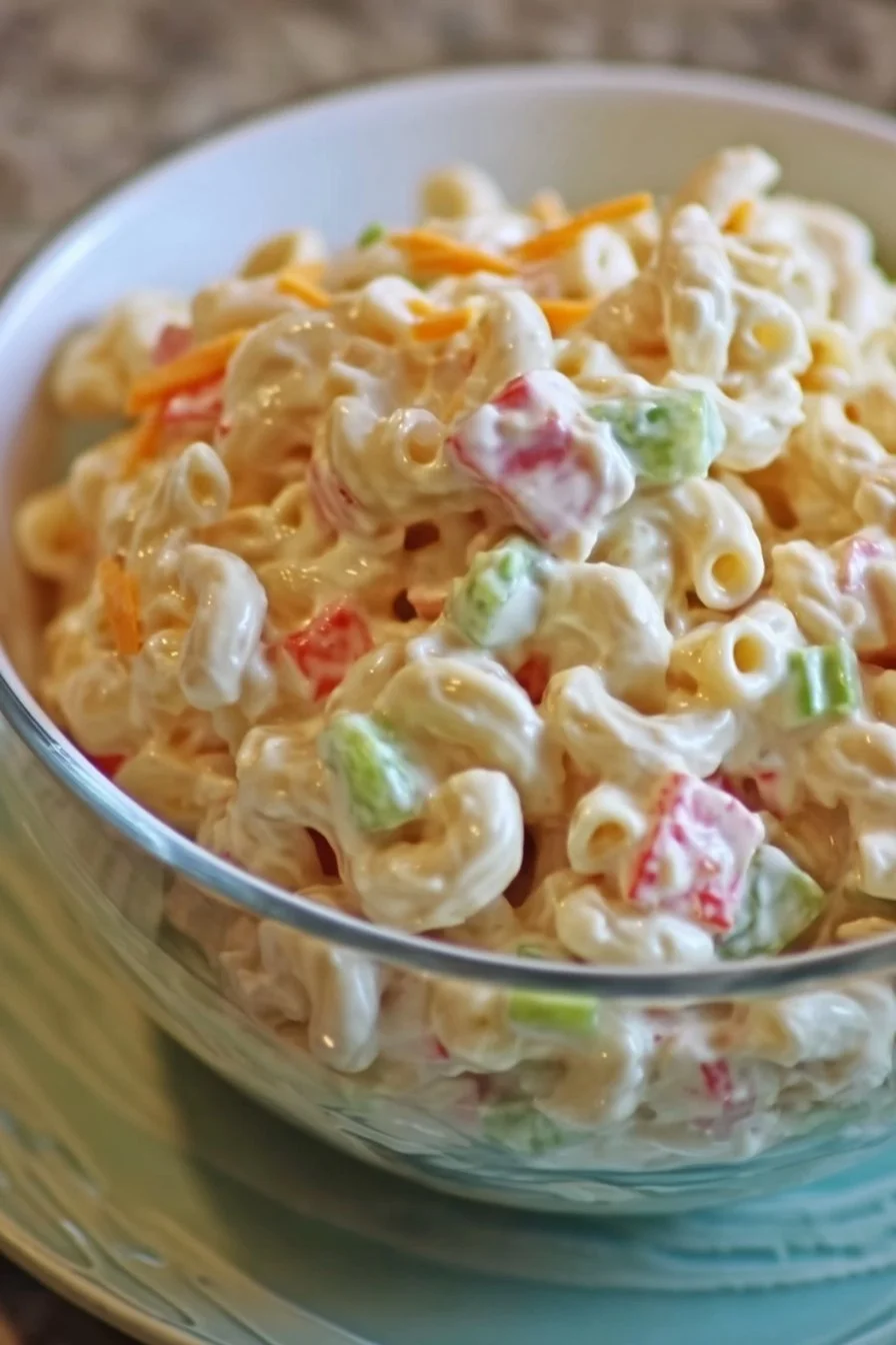 Delicious bowl of best macaroni salad with fresh vegetables and creamy dressing