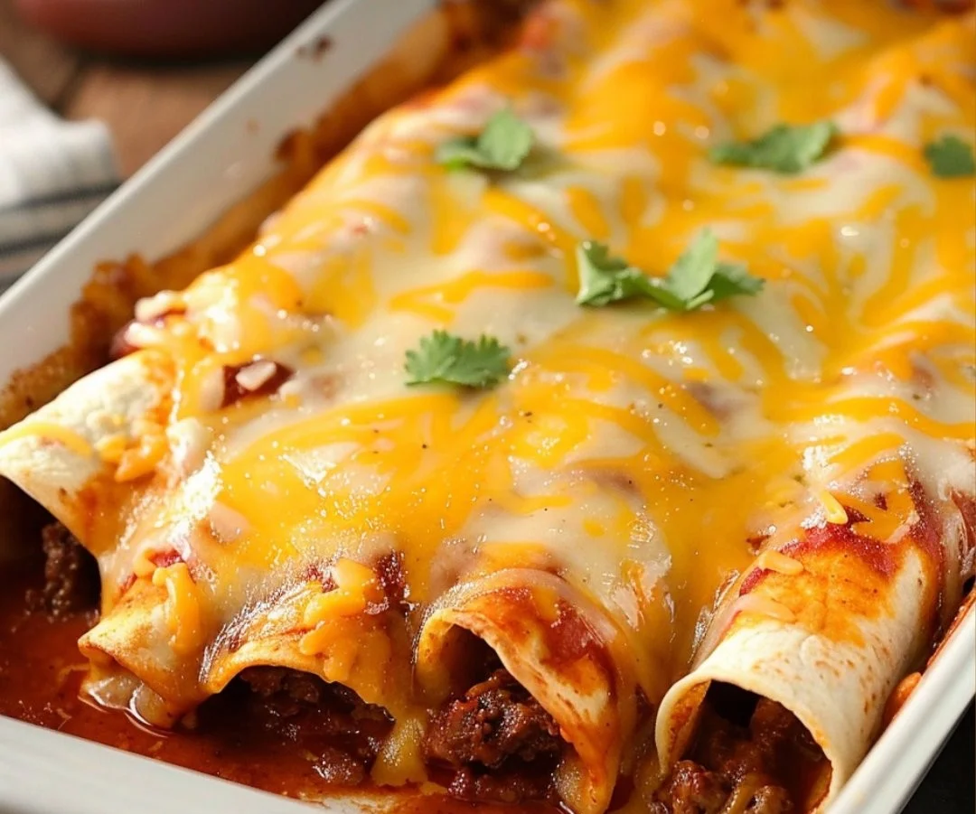 Cheesy 5-Ingredient Beef Enchiladas topped with sauce and cheese