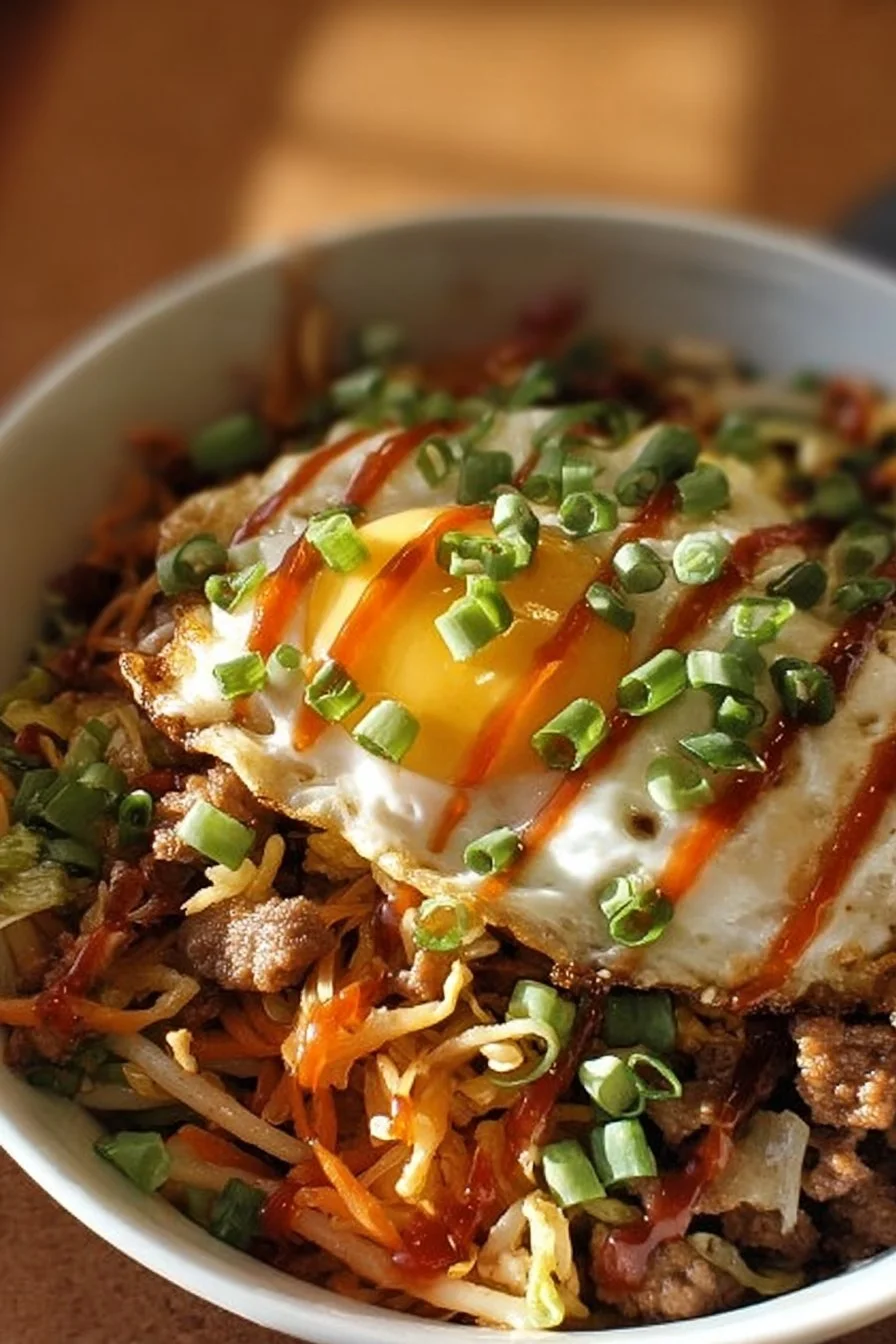 Delicious egg roll in a bowl topped with fresh ingredients and sauces
