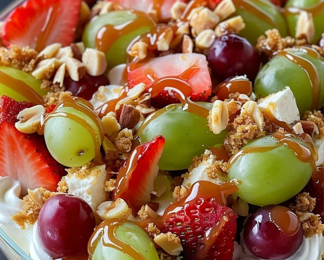 Caramel crunch cheesecake fruit salad served in a bowl with fresh fruit toppings.