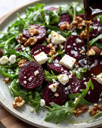 Roasted beet and arugula salad garnished with nuts and feta cheese