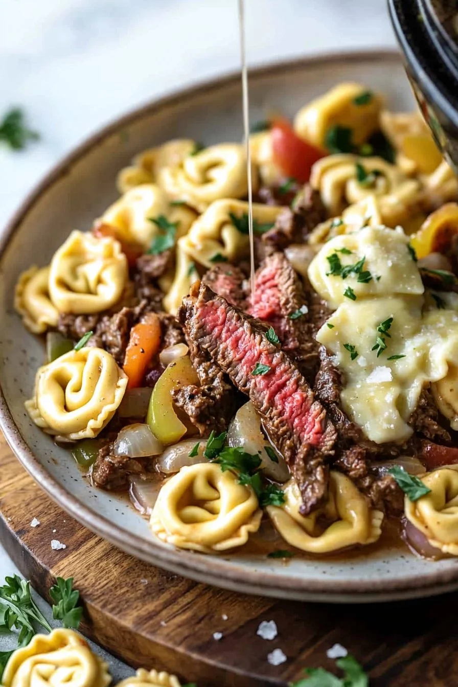 Slow Cooker Cheesesteak Tortellini served in a bowl with herbs