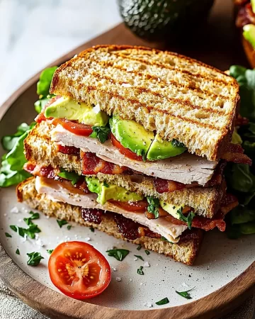 Delicious Turkey Avocado Club Sandwich with fresh ingredients and crispy bacon
